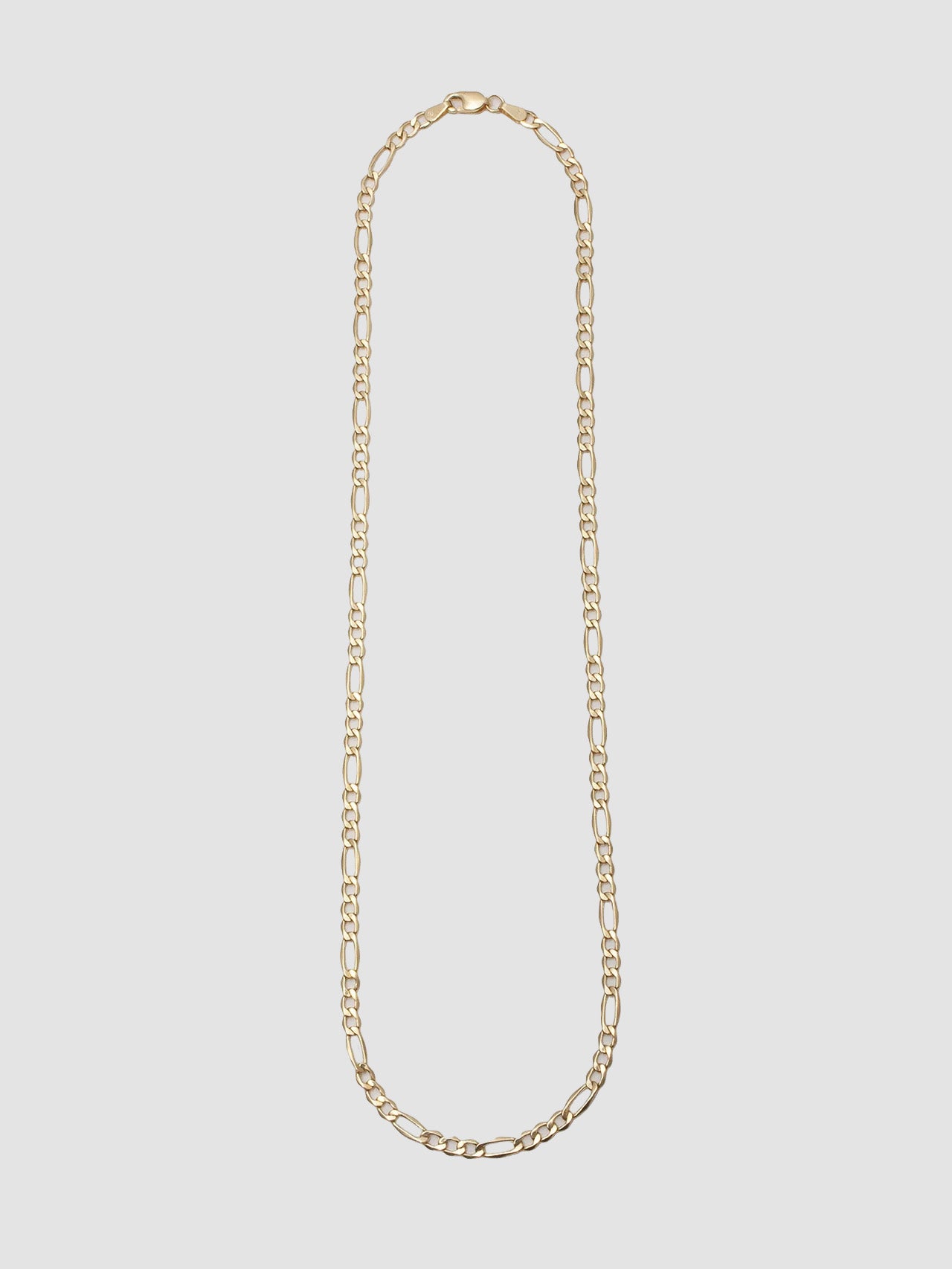 14kt Yellow Gold Hollow Figaro Chain Necklace pictured on light grey background. 