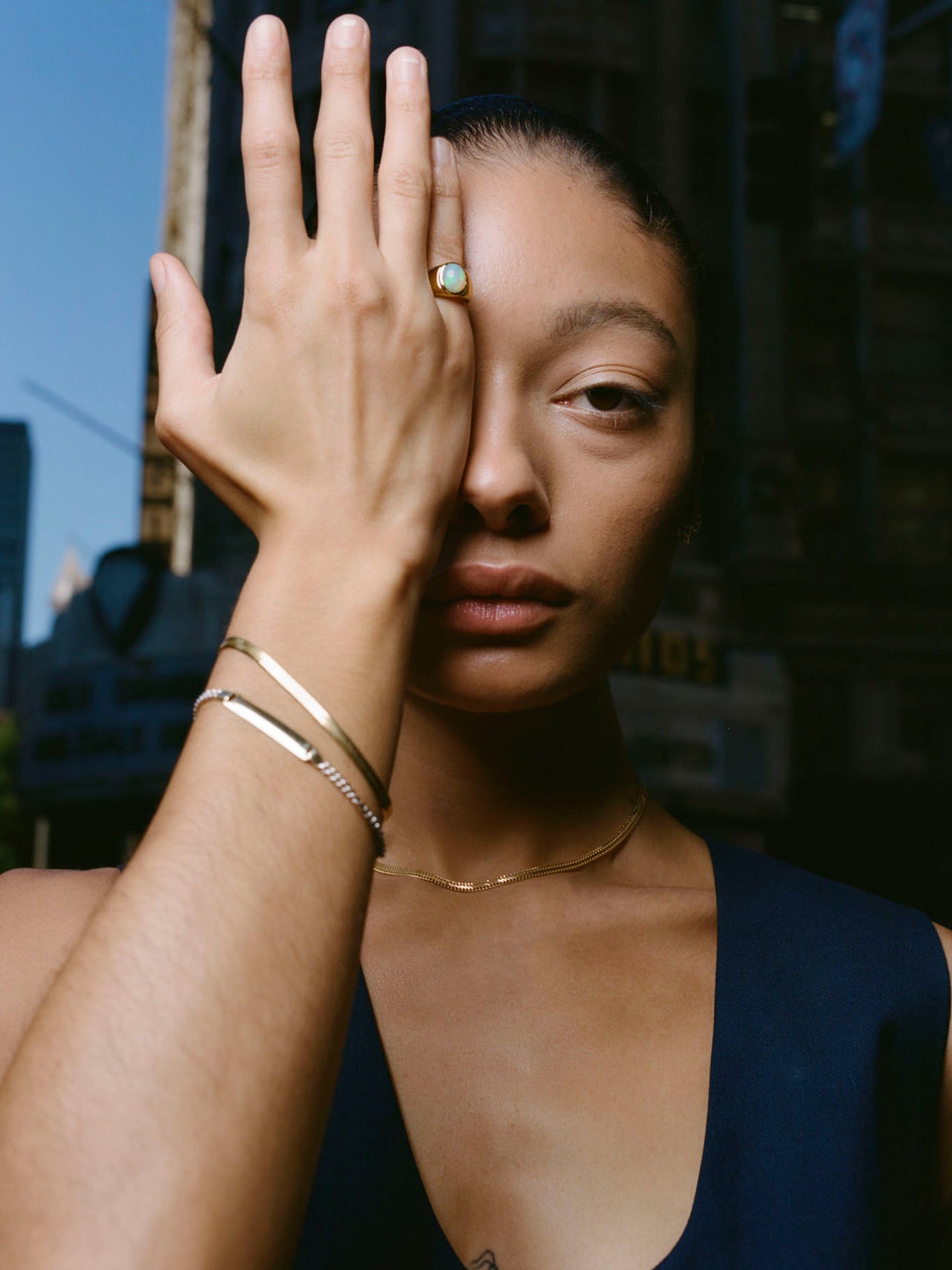 Vermeil Herringbone Bracelet pictured on models wrist. City in background.