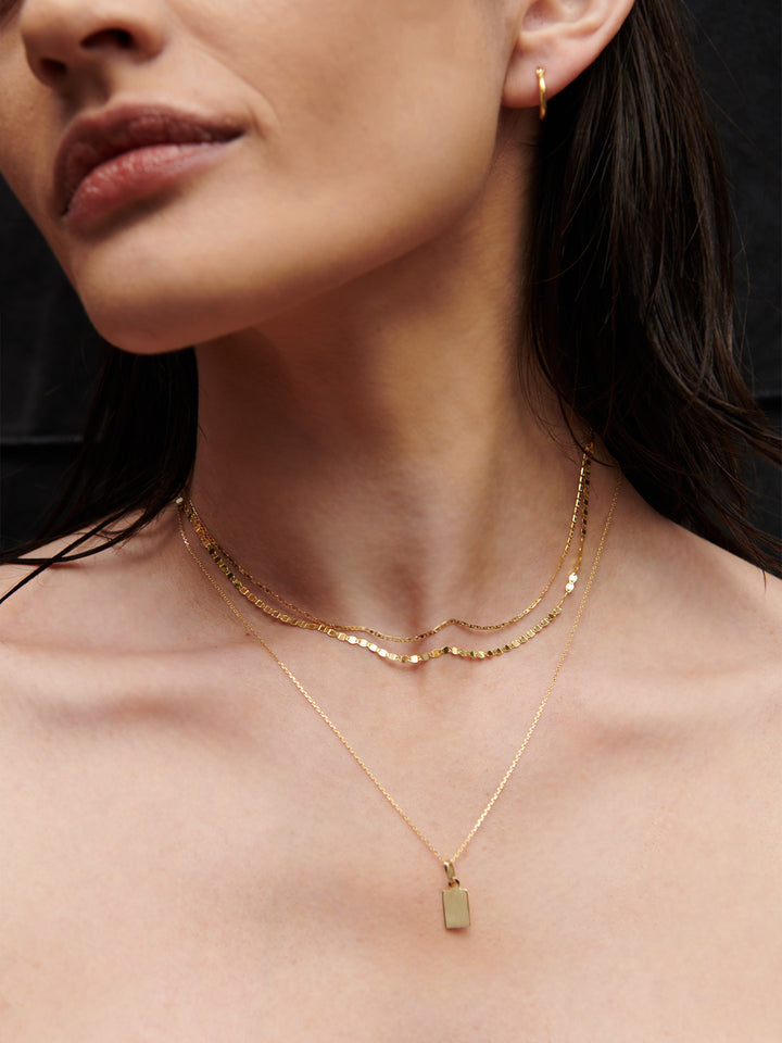 Baby Sol Valentino necklace shot on model.
