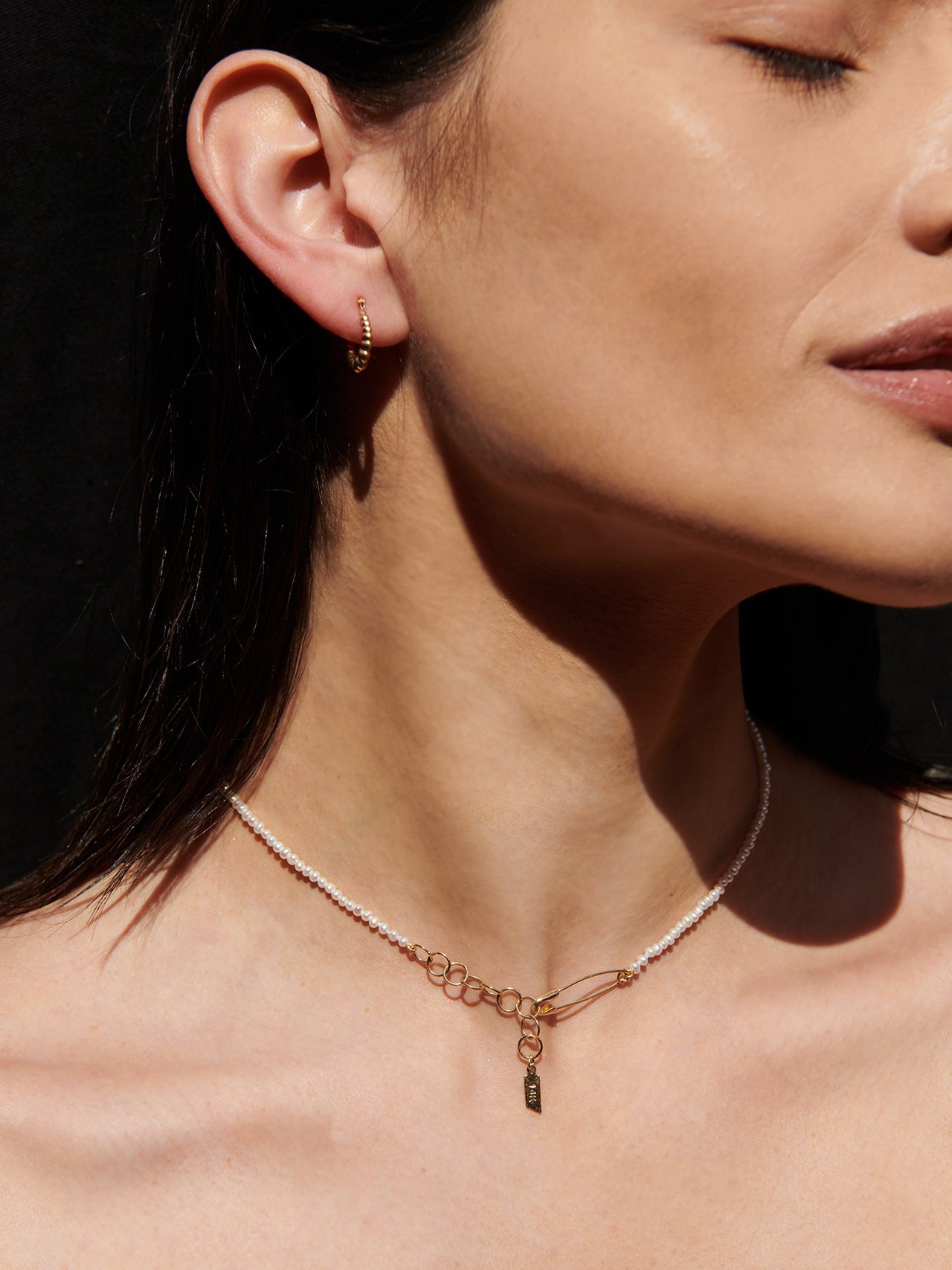 14kt yellow gold bolla hoops shot on models ear. 