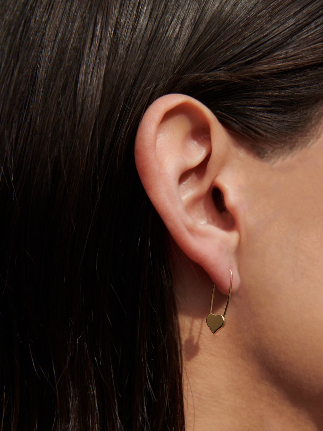 14Kt Gold Heart Safety Pin Earring pictured on model. 
