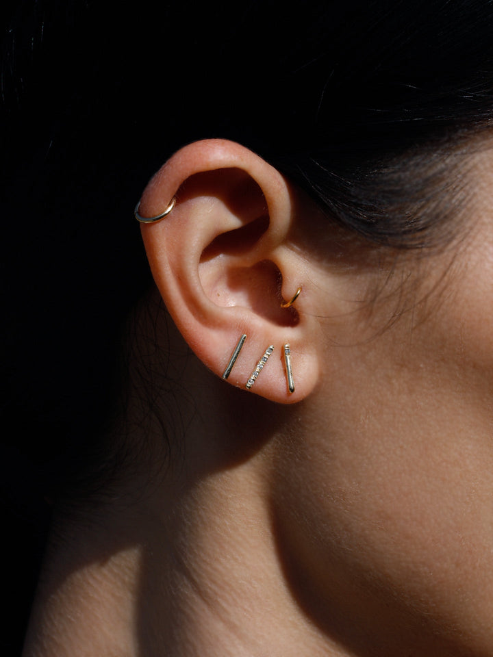 Diamond rod stud pictured on models ear. 