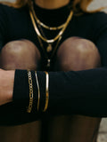 Vermeil Herringbone Bracelet pictured on models wrist. Styled with the XL Figaro and Demi Herringbone Bracelets. 