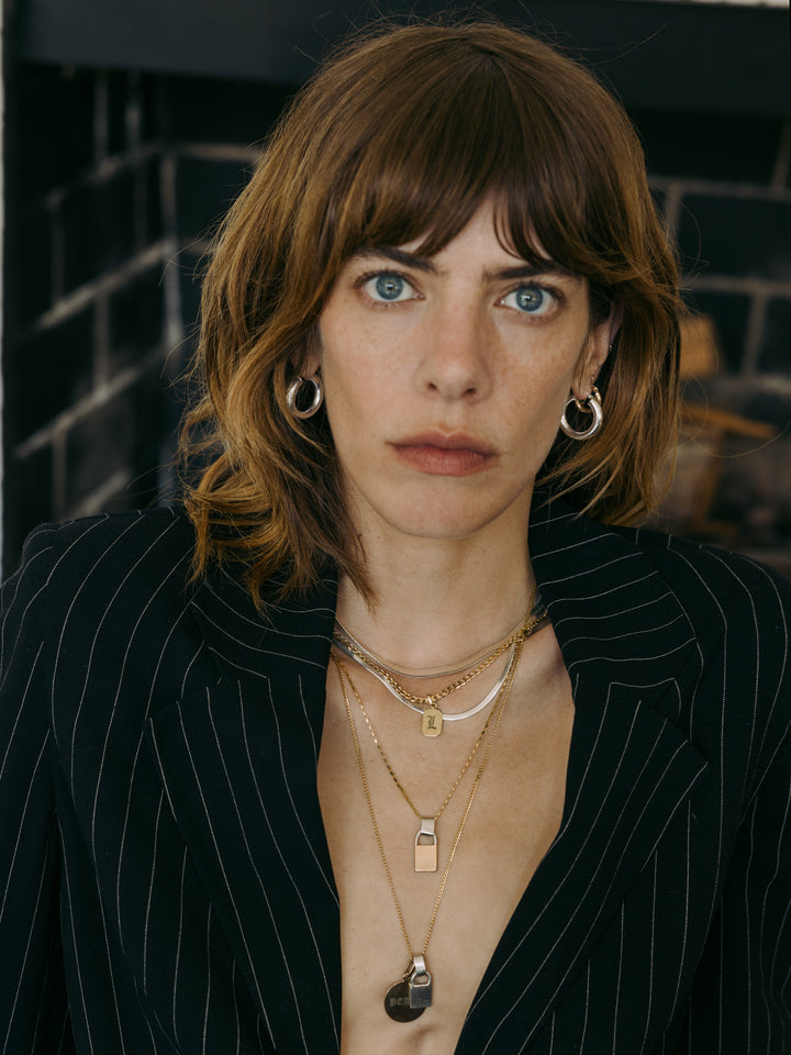 Sterling Silver Tube Hoops pictured on model. 