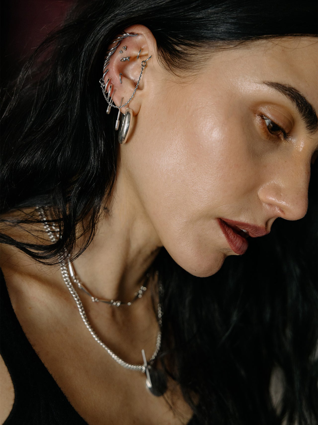 Sterling Silver Mini Safety Pin Earring pictured in models second piercing. 