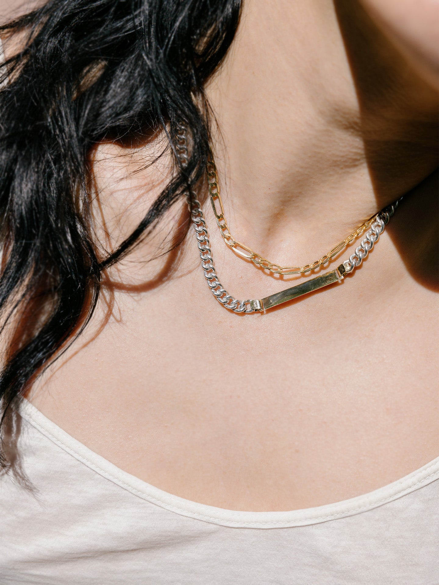 Mixed Metal Watts ID Necklace pictured on model styled with the 14k Gold XL Figaro Chain.  