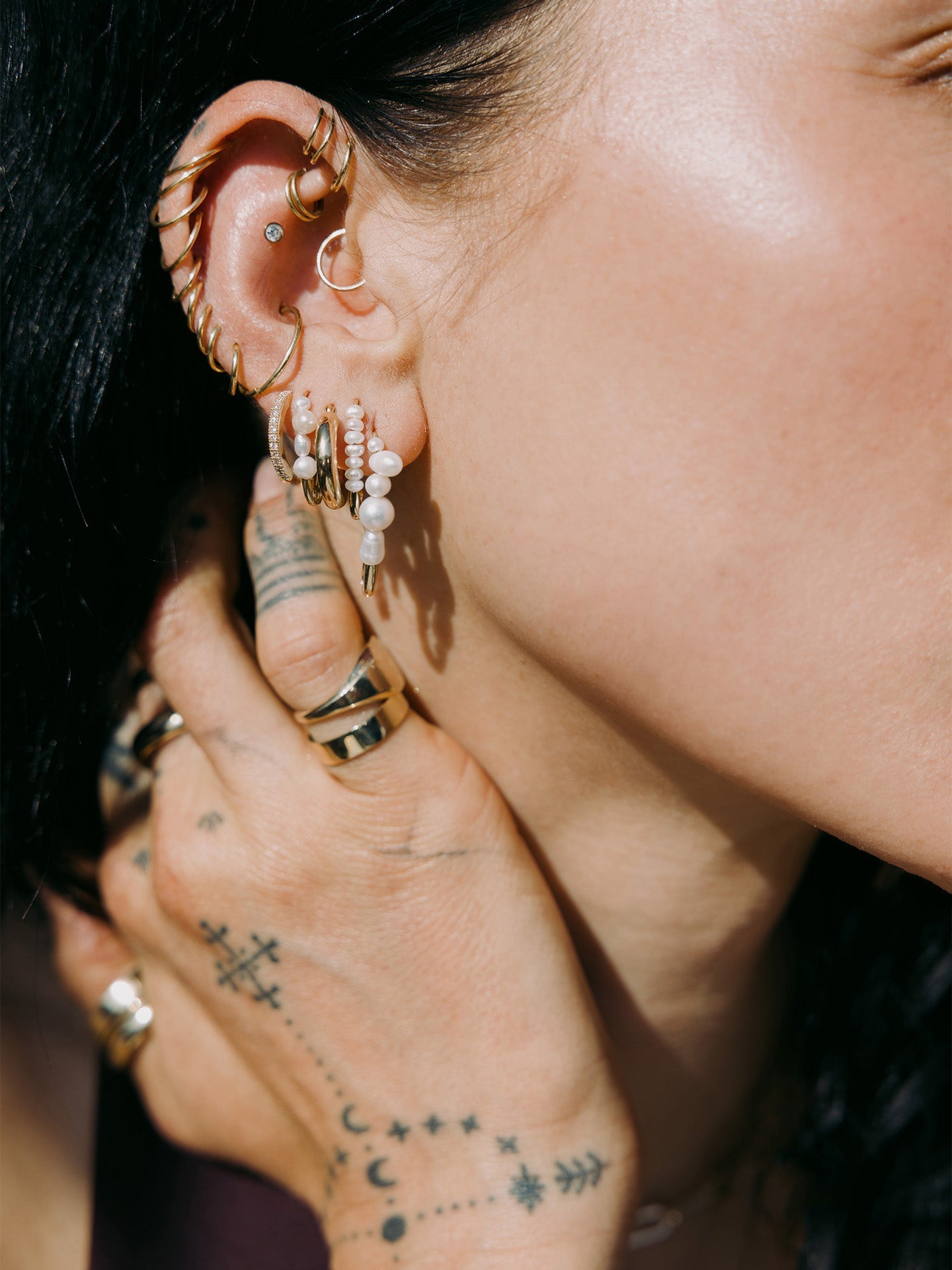 Mini Mixed Pearl Safety Pin featured in models fourth piercing. Styled with other best sellers.