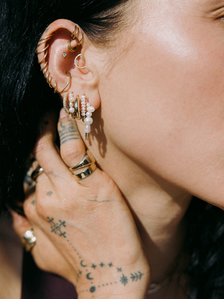 Mini Mixed Pearl Safety Pin featured in models fourth piercing. Styled with other best sellers.