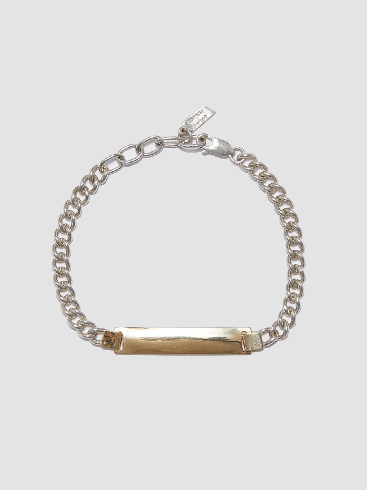 Watts ID Bracelet: Sterling Silver Curb Chain with a 14Kt Gold ID Centerpiece Length: 7’ (adjustable)