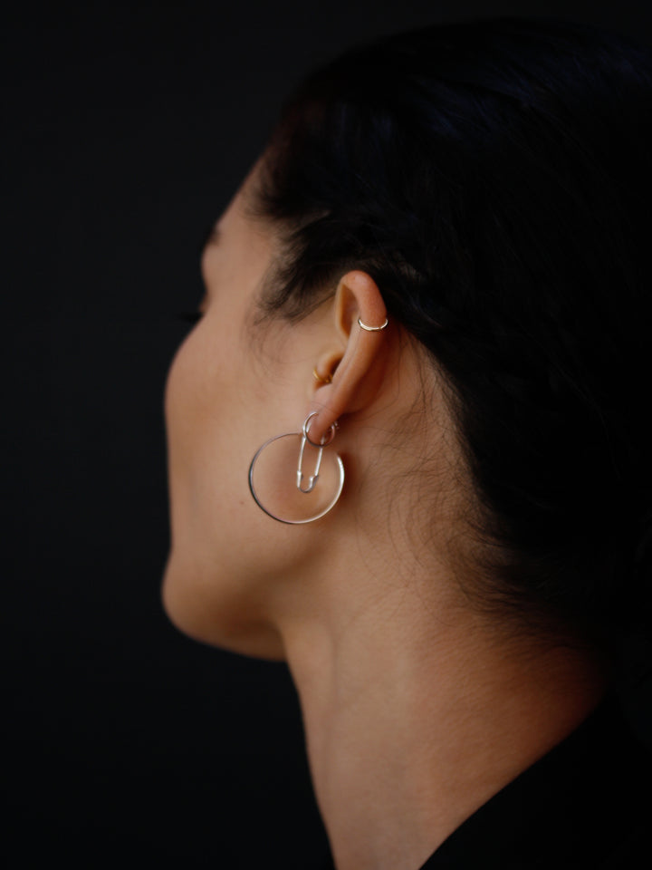 XL Dome Hoops pictured from side view on model. Black background. 