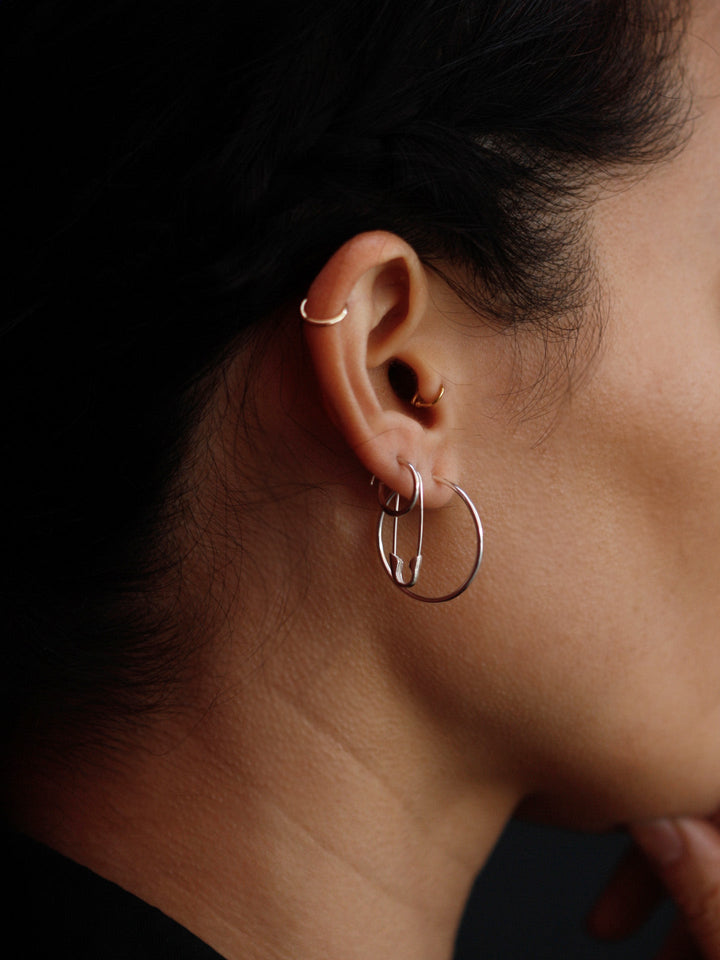 Sterling Silver Safety Pin Earring pictured in models ear. Second piercing. 