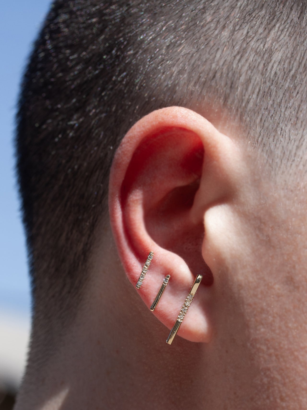 14kt Yellow Gold Solo Diamond Rod Stud Earring pictured in third piercing. Also pictured is the long diamond rod and solo diamond rod stud.