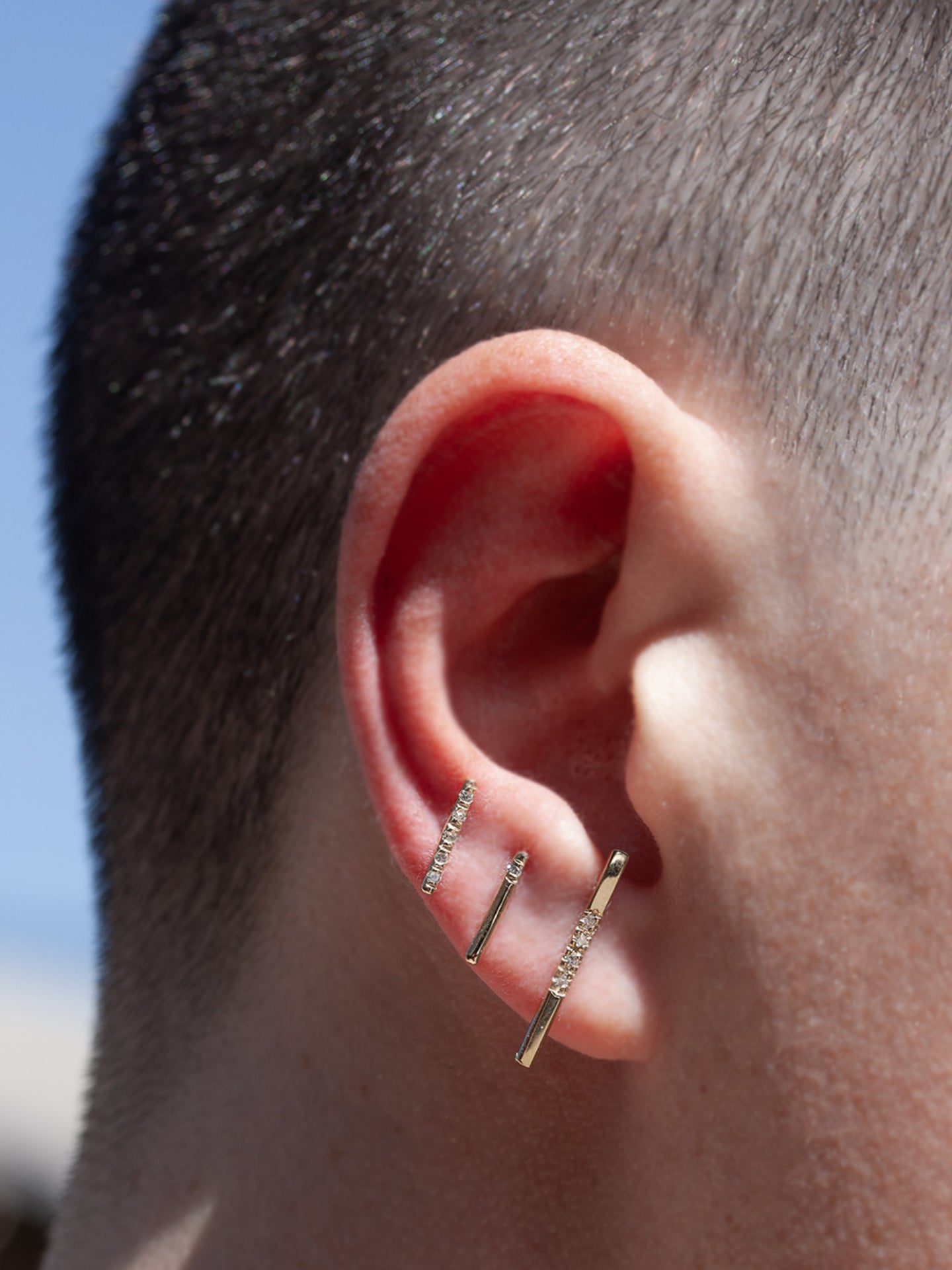 14Kt Yellow Gold Diamond Rod Stud Earring pictured in models first piercing. 