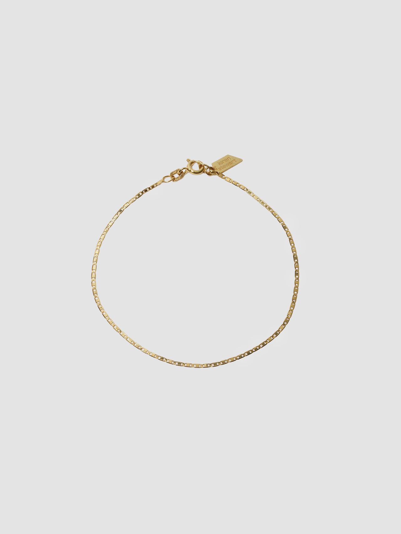 10kt Yellow Gold Valentino Chain Bracelet pictured on light grey background.