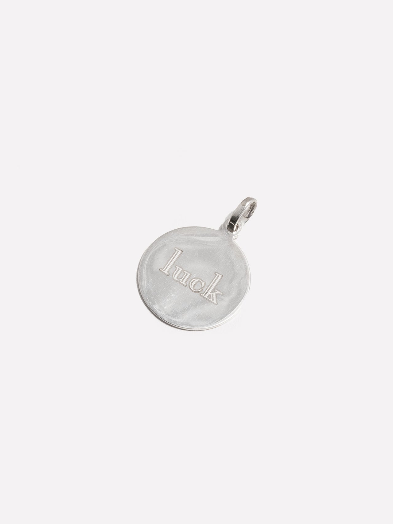 Sterling Silver Disk Pendant engraved with luck in block font. 
