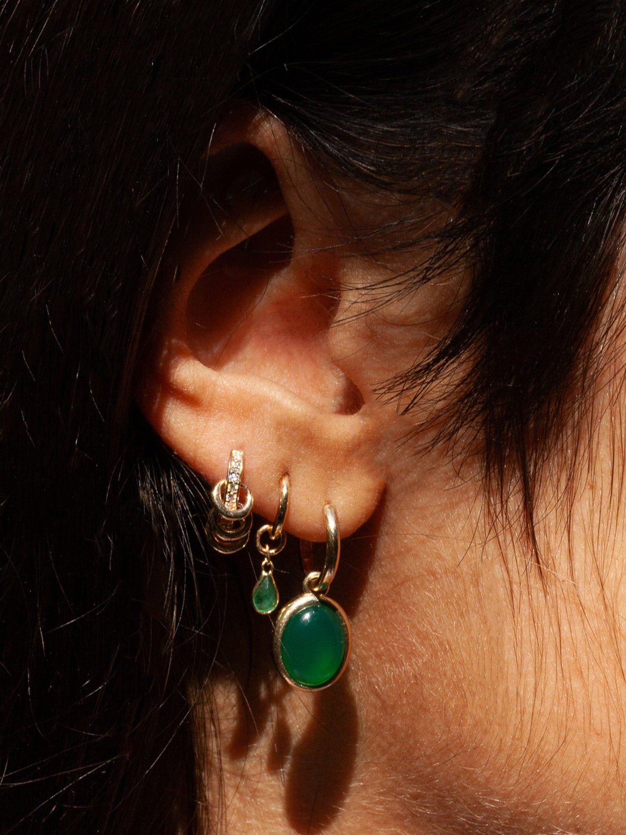 14kt Yellow Gold Pierced CZ Huggies pictured in models third piercing. 