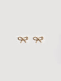 14kt Yellow Gold Mini Bow Studs pictured on light grey background.  