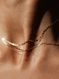 Sol Valentino Necklace pictured layered with the Baby Sol Valentino Necklace. Worn on models neck. Close up shot. 