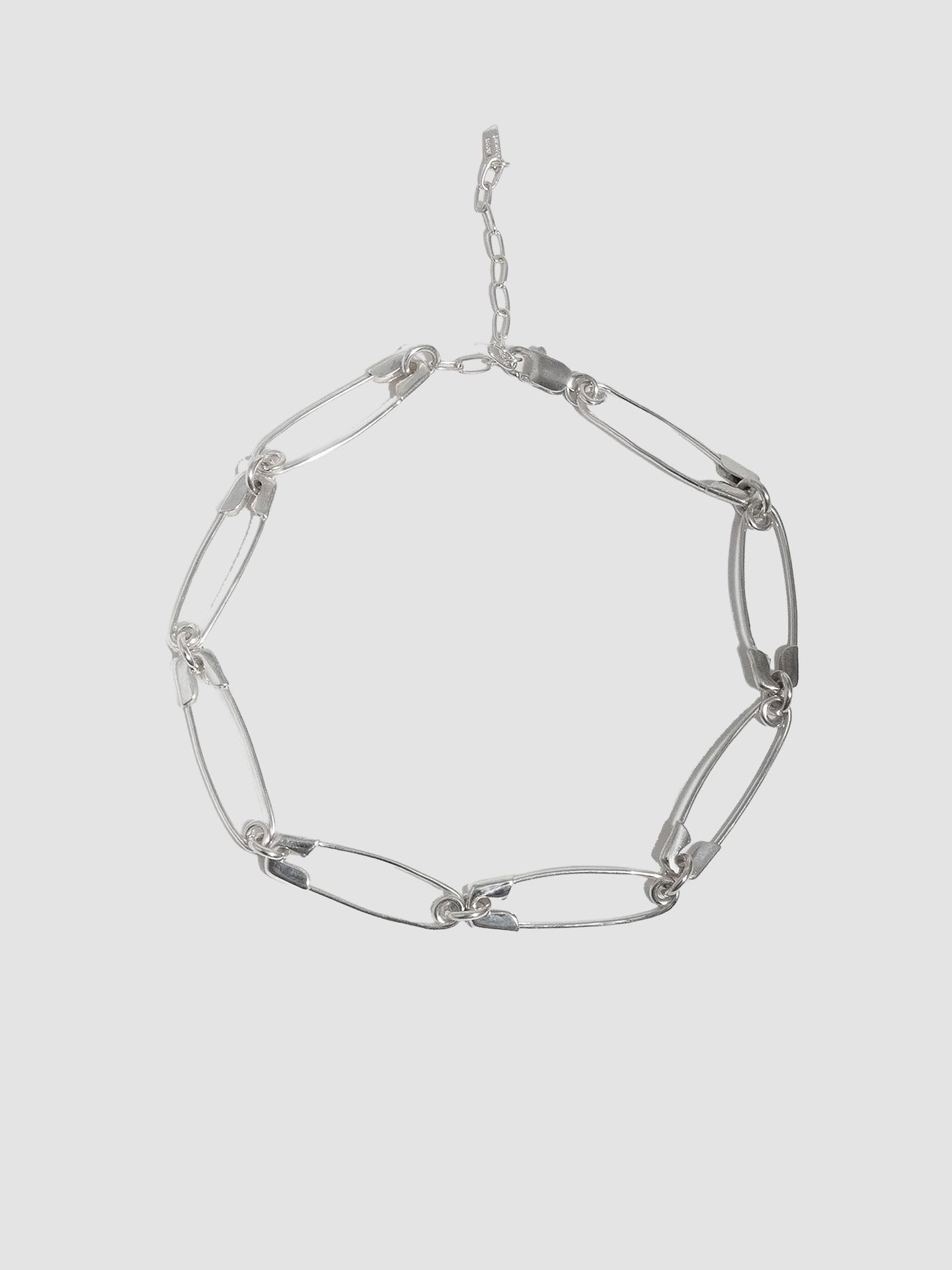 Sterling Silver Safety Pin Link Chain pictured on light grey background. 