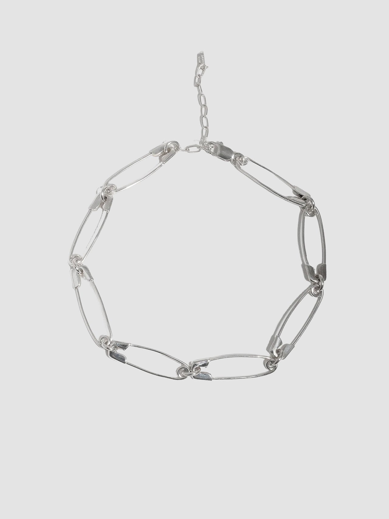 Sterling Silver Safety Pin Link Chain pictured on light grey background. 