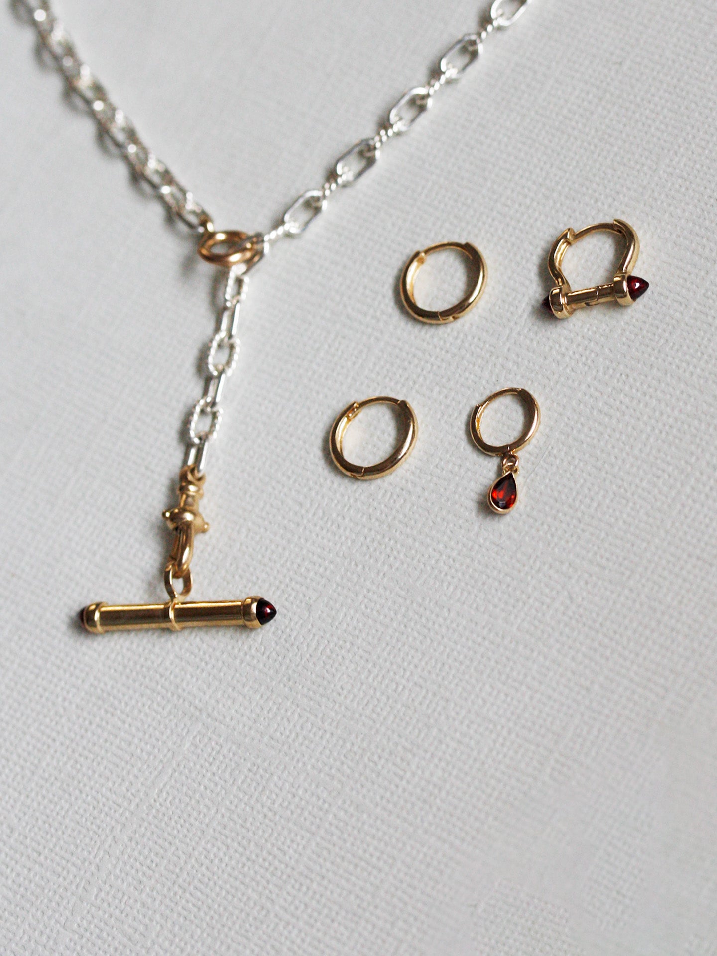 Jewelry set with necklace and earrings on a light gray background