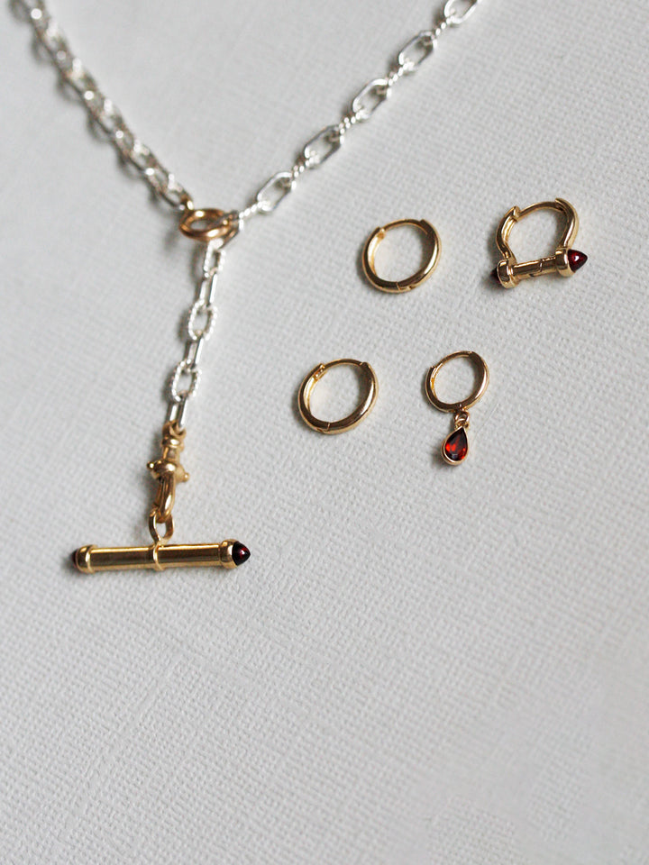 Jewelry set with necklace and earrings on a light gray background