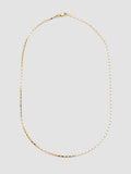 Gold necklace on a light gray background