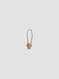 Skull Safety Pin earring on light grey background.