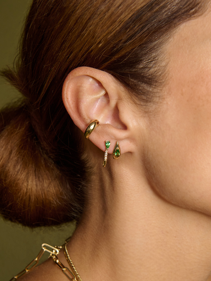 14kt Yellow Gold Mini Diamond Tsavorite Safety Pin pictured in models second piercing. 