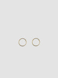 Product shot of the Valle Hoops (14Kt Yellow Gold Hoops 0.47” Diameter Thickness: 1mm) Background: Grey Backdrop