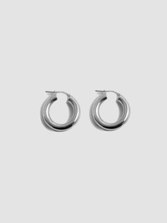 Product shot of thick sterling silver tru hoops shot on white background.