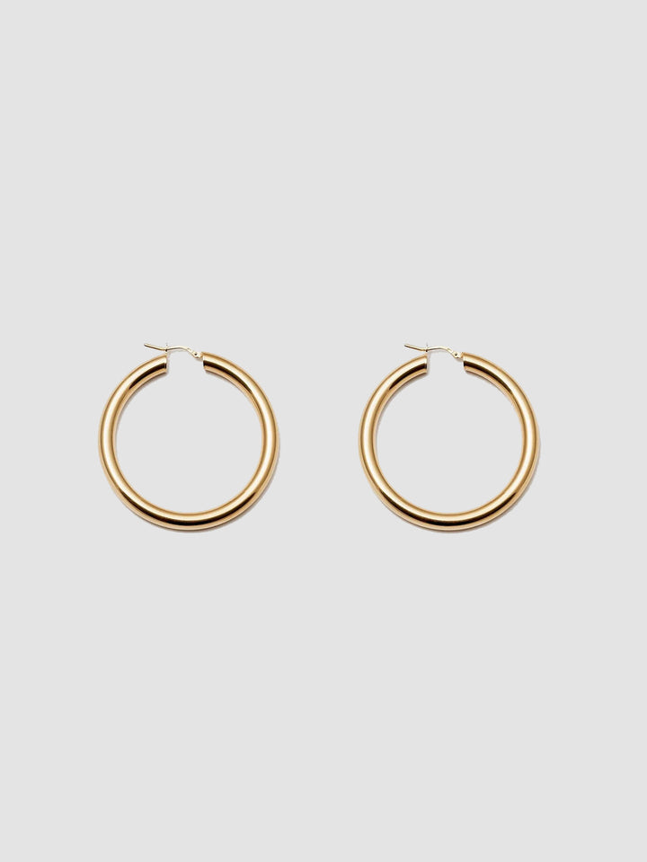 Product Shot of the Tru Hoops in Vermeil gold (Vermeil Hoops 49.5mm diameter 5mm thick) Background: Grey backdrop