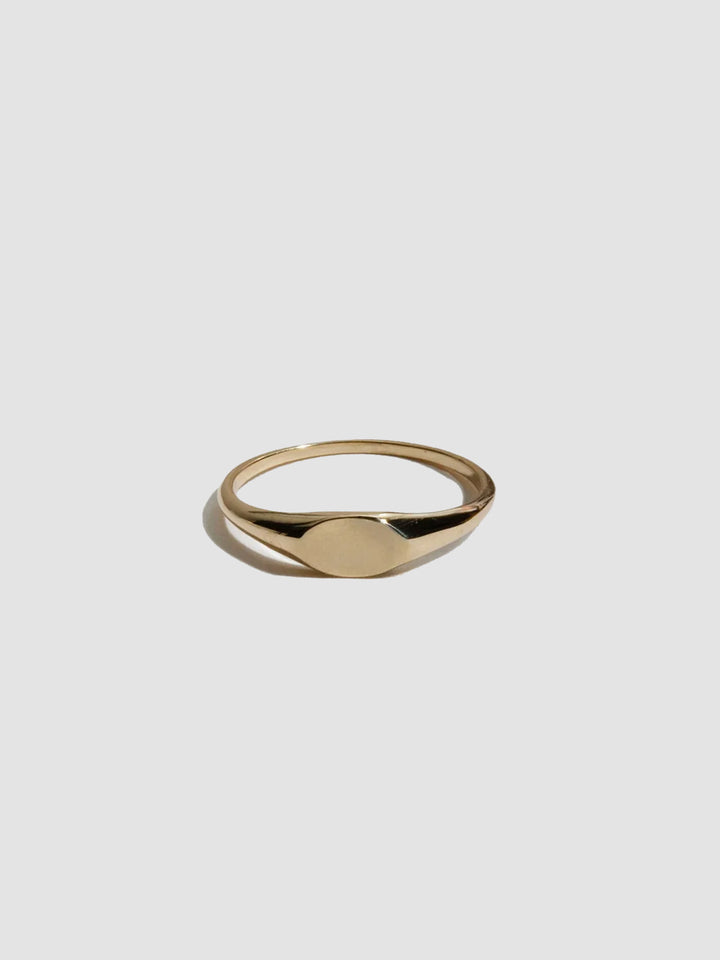 Gold ring on a light gray background