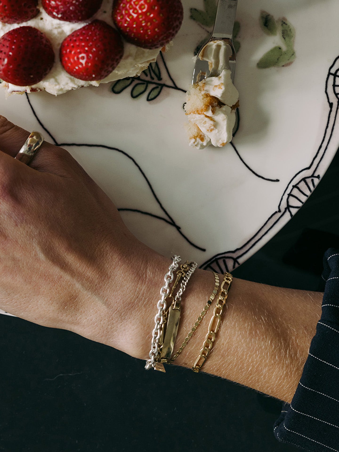 Classic Cable Bracelet pictured on models wrist stacked with other bracelets.