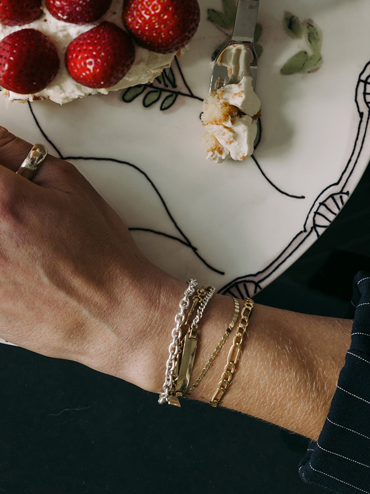 Classic Cable Bracelet pictured on models wrist stacked with other bracelets.