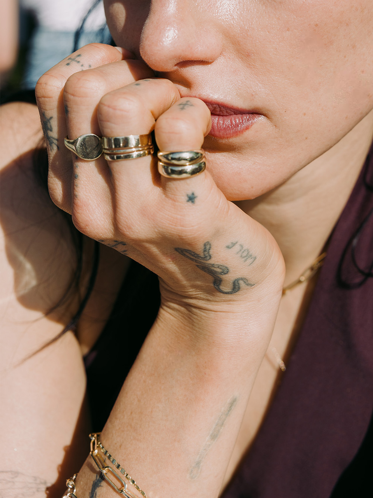 14kt Yellow Gold Hug Band pictured on models ring finger, stacked with other classic bands.