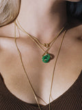 On Model shot of the Mini Jade Anais (14kt Yellow Gold Chain Jade Links: 16×4mm) along with the Blitz Collar Necklace (Yellow Gold Vermeil RX Chain Width: 6mm)  Background: Green 