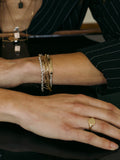 Mini Watts ID Bracelet pictured on models wrist. Layered with other bracelets.