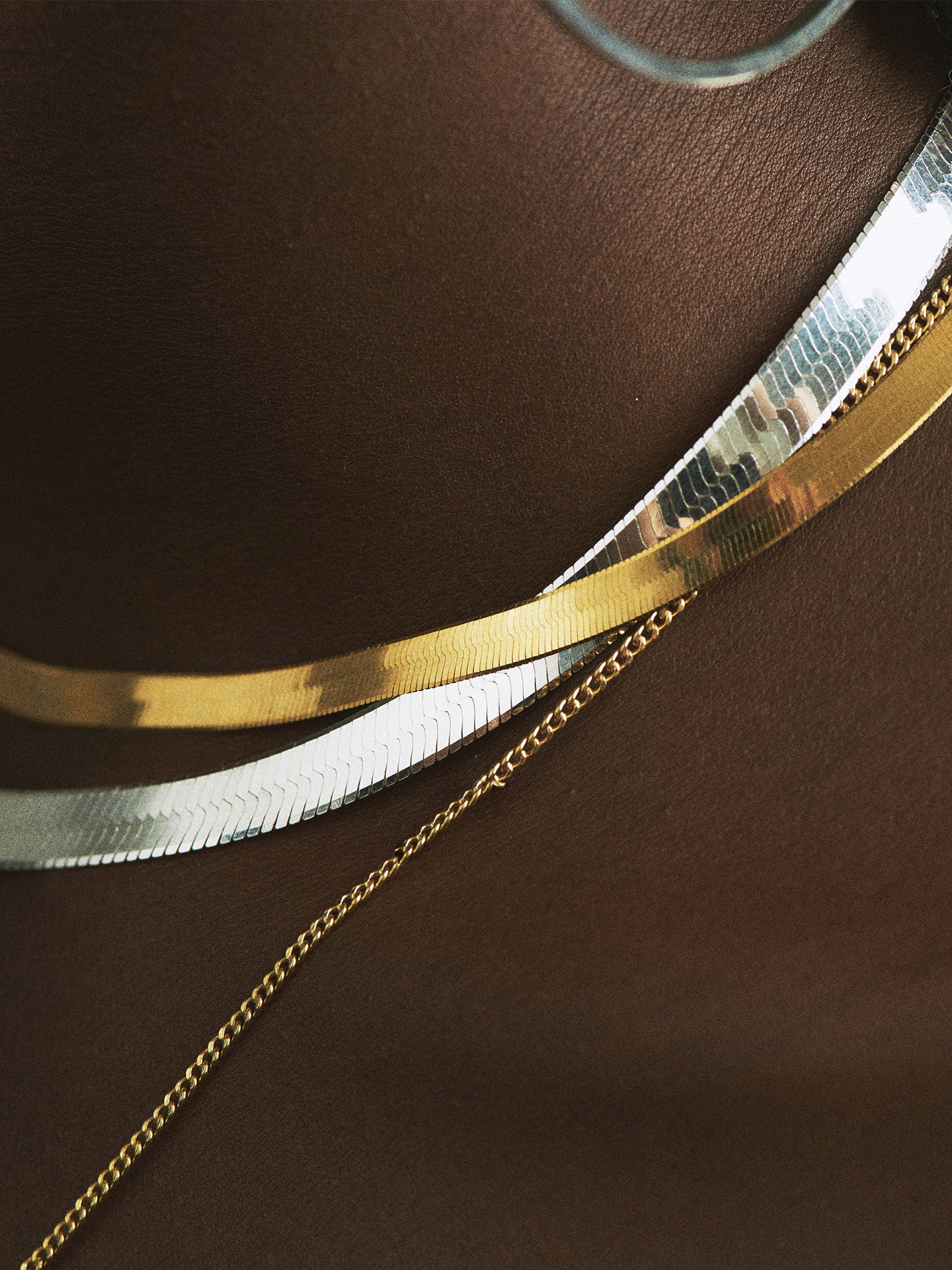 Sterling Silver Herringbone Chain Necklace pictured on model layered with the Vermeil and 14k Petite Havana Chain. 