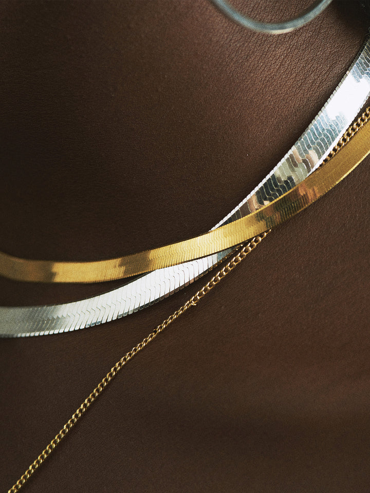 Sterling Silver Herringbone Chain Necklace pictured on model layered with the Vermeil and 14k Petite Havana Chain. 