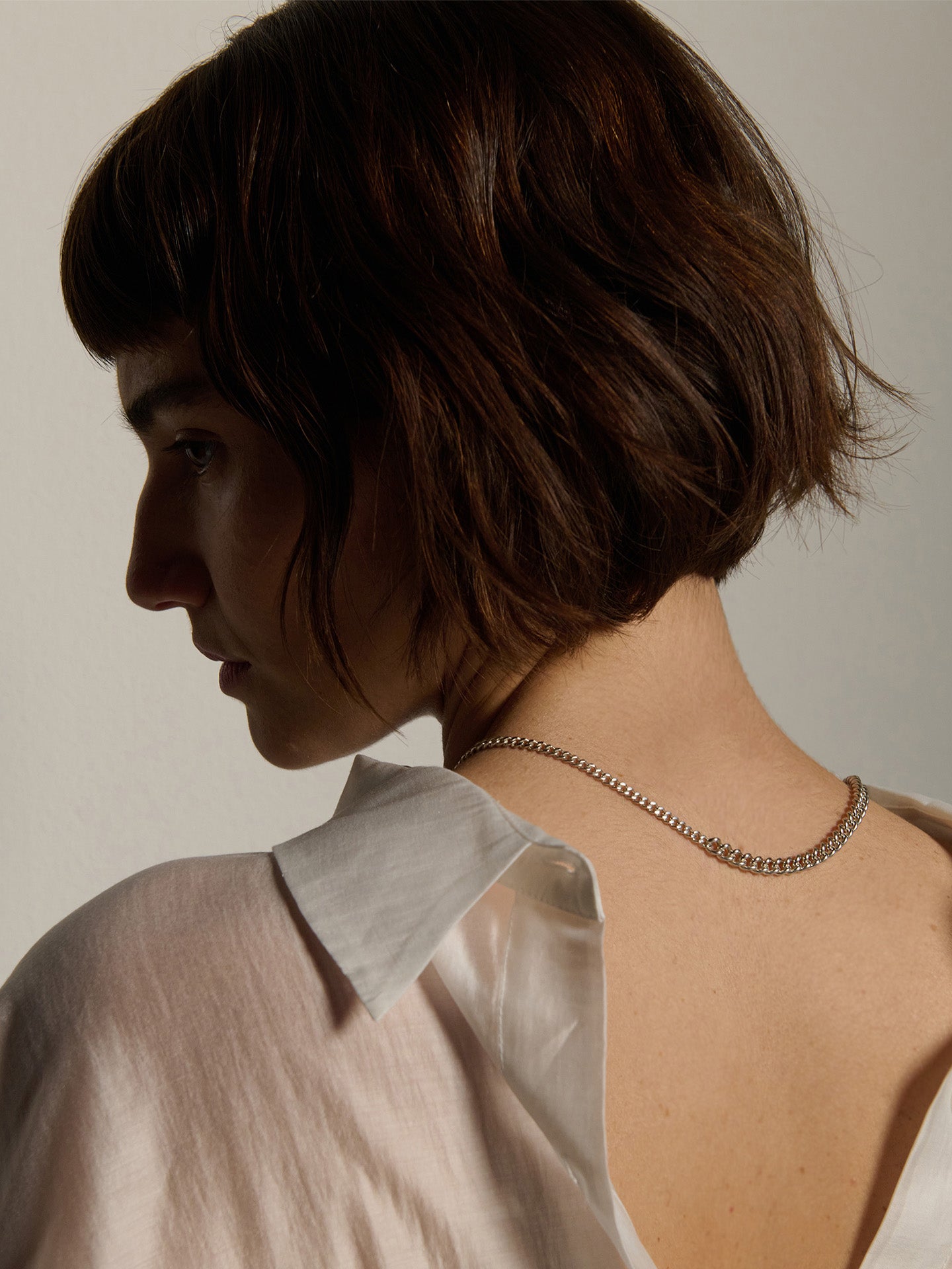 Sterling Silver Solid Scout Barbell Toggle Necklace pictured from the backside of model. Showing off the two different width curb chains. 