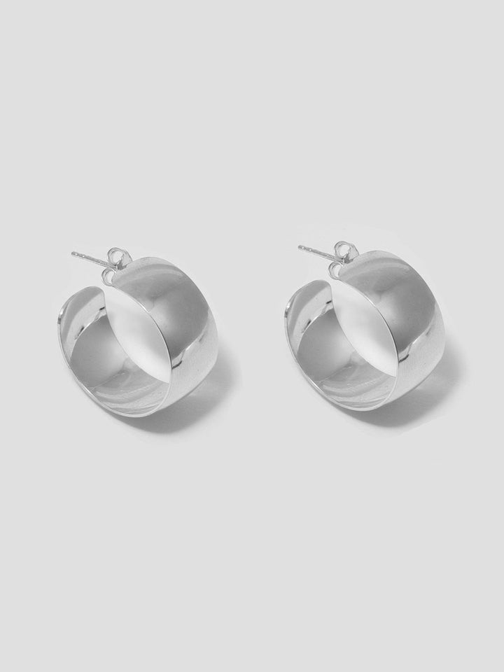 Product shot of the XL Dome Hoops(Sterling Silver Hoop Earrings 30mm Diameter 12mm Wide) Background: Grey backdrop
