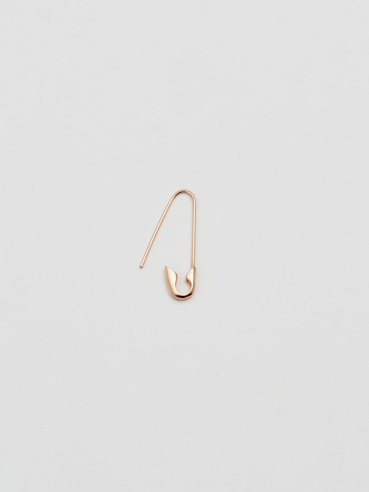 Product shot of the Safety Pin Earring with clasp open(14Kt Shiny Rose Gold Safety Pin Earring Length: 21.35mm) Background: Grey backdrop
