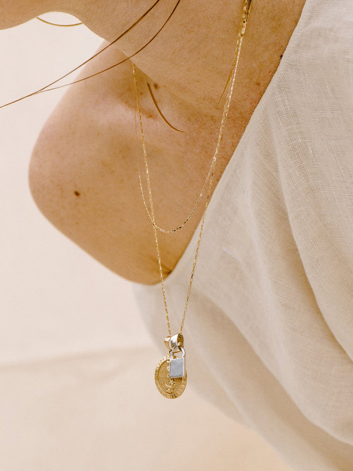 Petite Industrial Box Link Chain styled on model with various other chains/necklaces