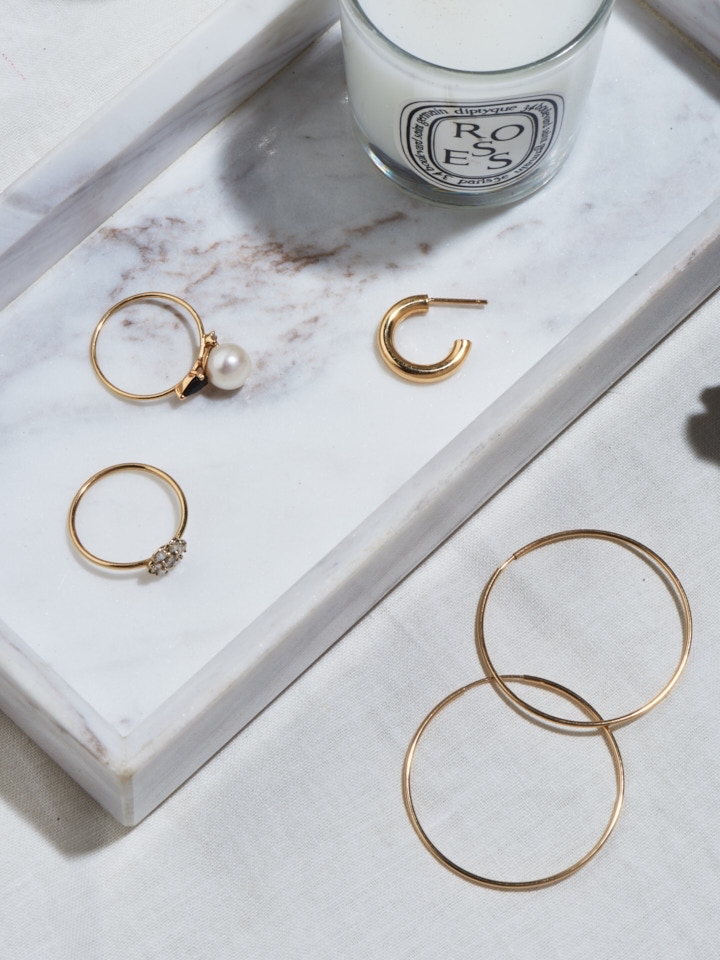 14Kt Yellow Gold Ultralight Infinity Hoops  flat lay image. Vanity counter.