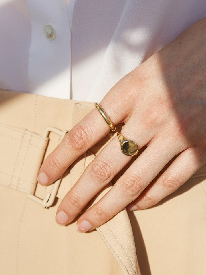 14kt Yellow Gold Baby Signet ring pictured on models middle finger.